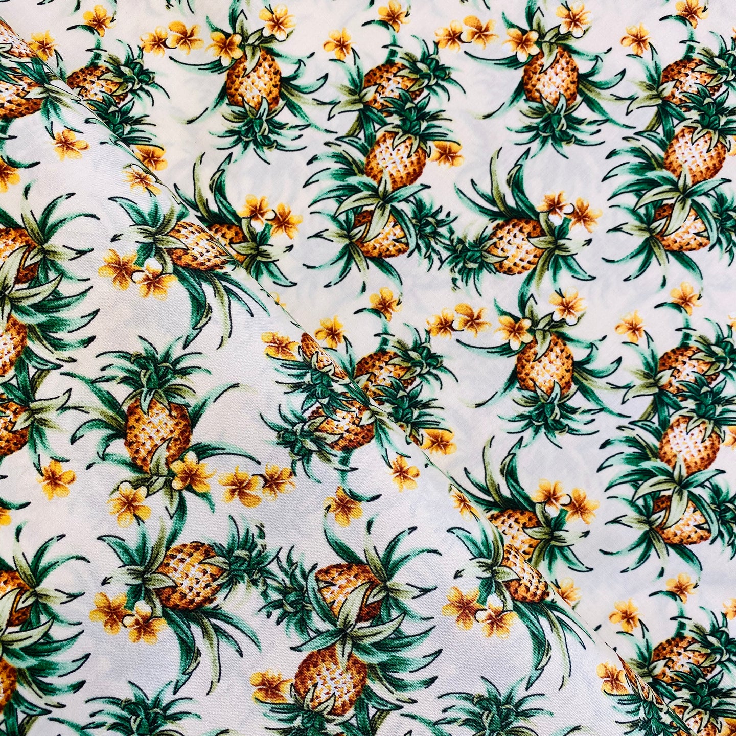 Pineapples and Flowers on Cream by Trans-Pacific Textiles, LTD, sold by the half-yard