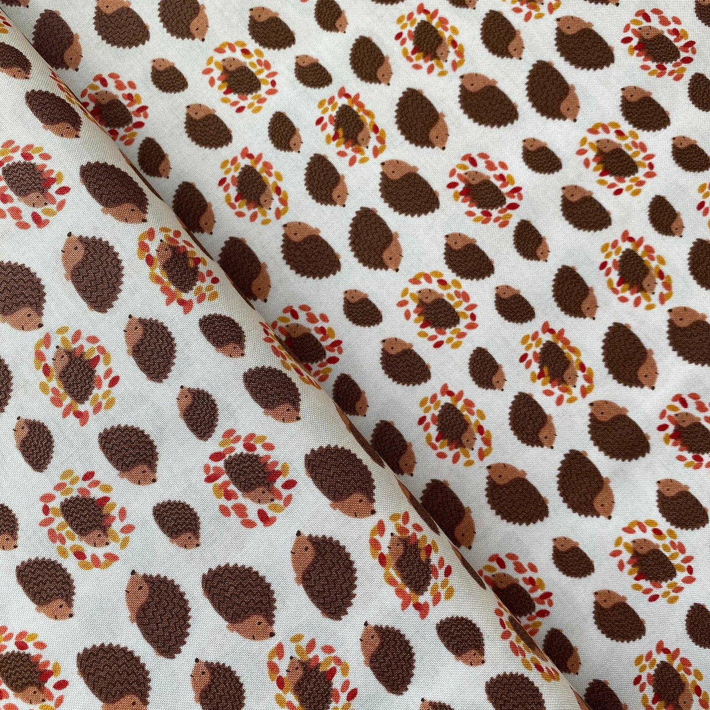 Hedgehogs & Leaves on Cream by Lewis & Irene, sold by the half-yard