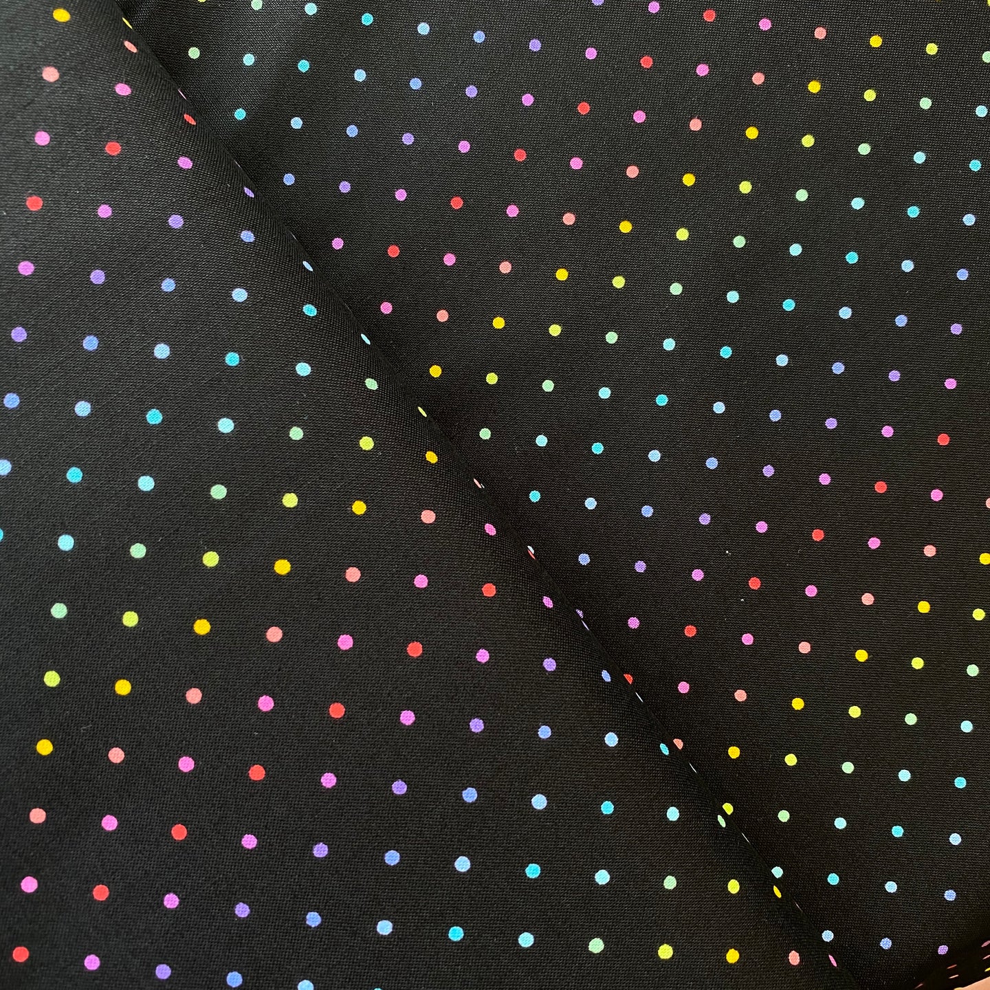Rainbow Sprinkles on Black by Andover, sold by the half-yard