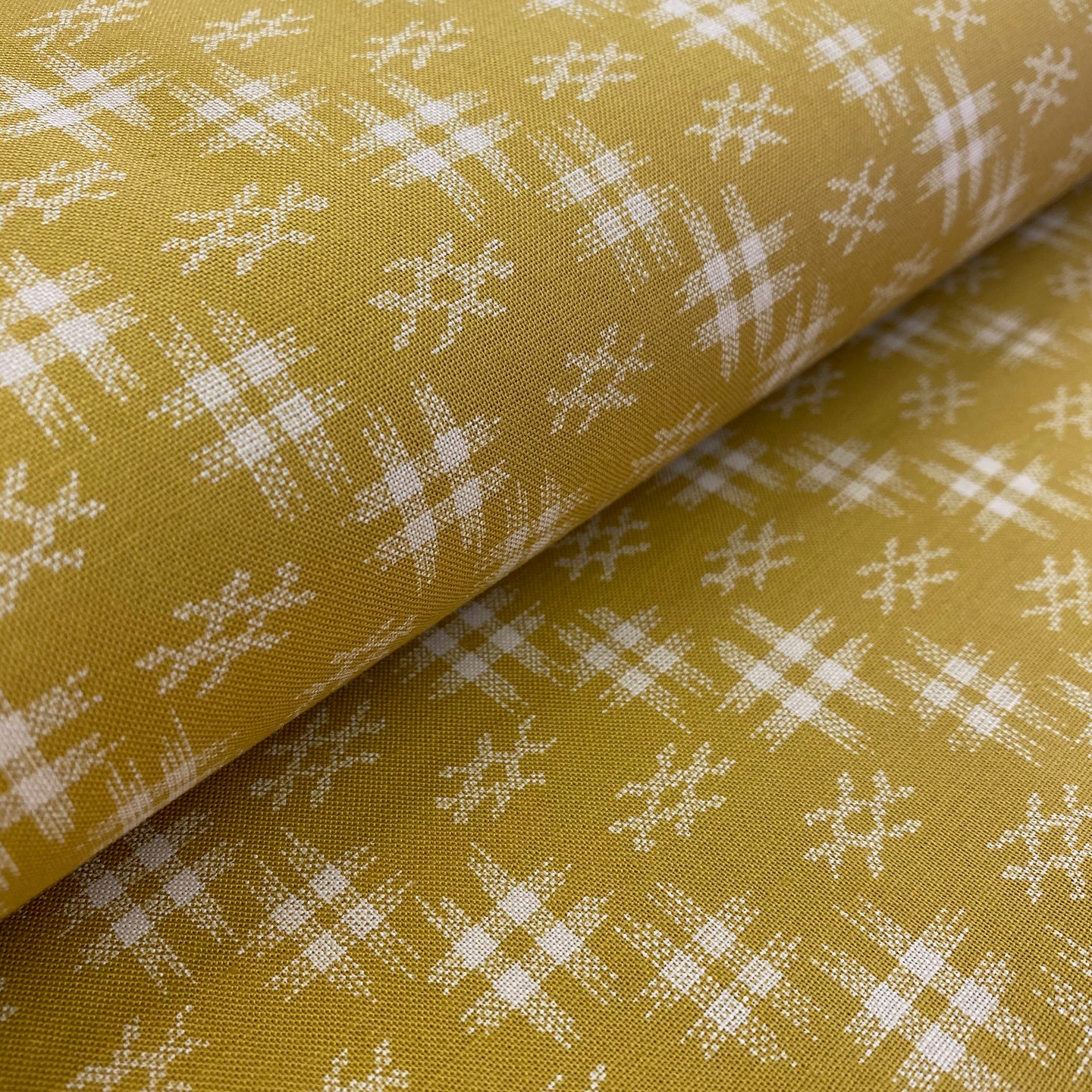 White on Dark Golden Textured Print by Westrade, sold by the half-yard