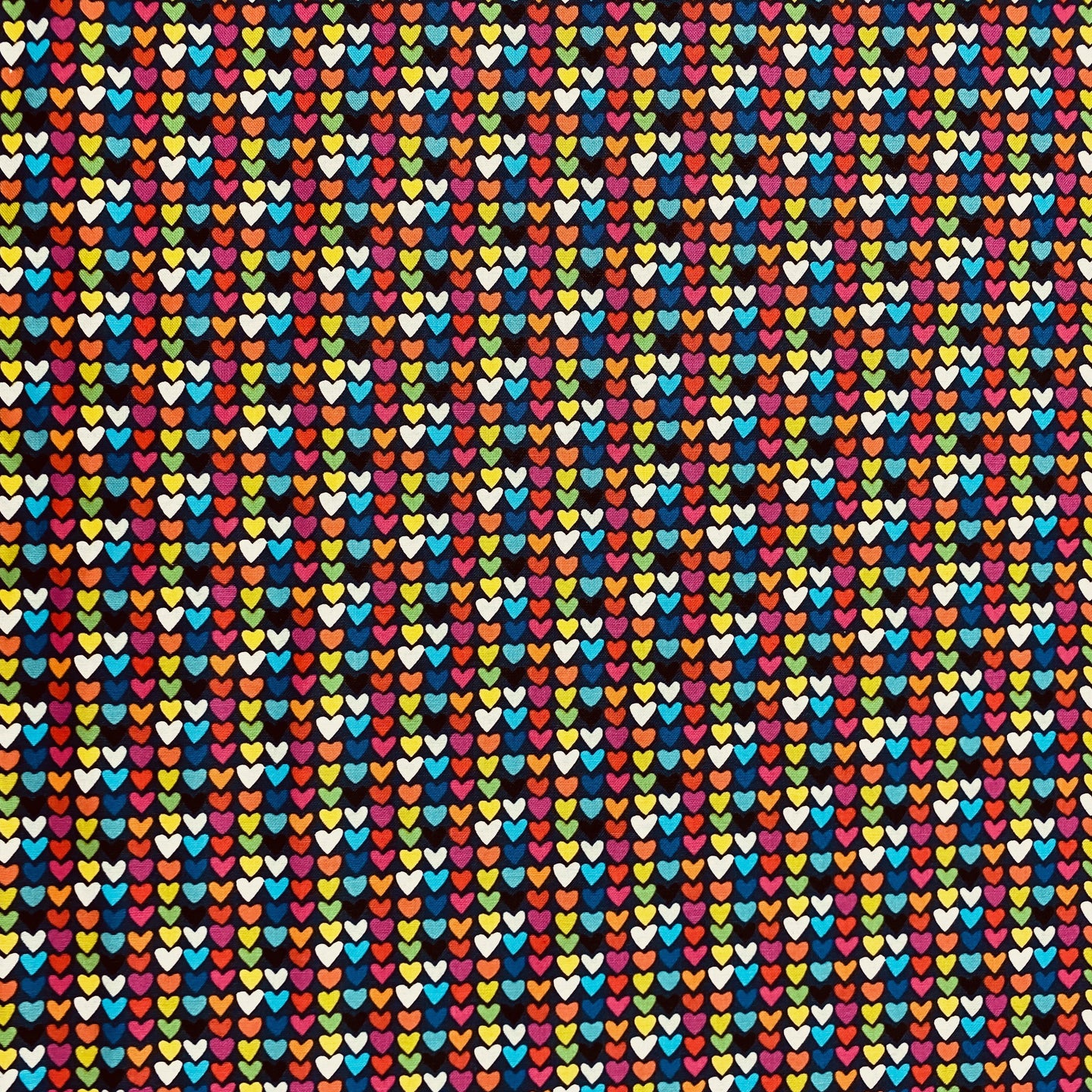 Happy Hearts in Multi on Navy Blue,  by Clothworks, sold by the half-yard